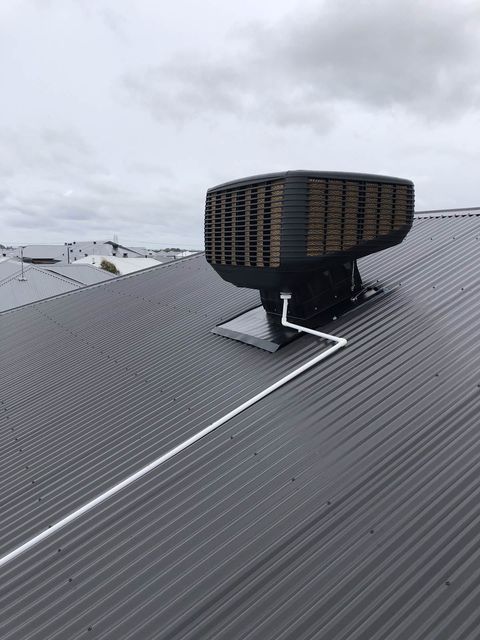 A rooftop evaporative cooler on a new estate home