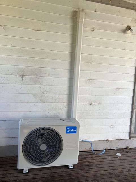 A split system outdoor unit on a timber deck