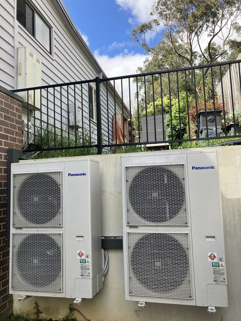 Two ducted outdoor units on a retaining wall