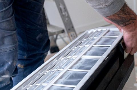 Lifting a new split system indoor unit into place